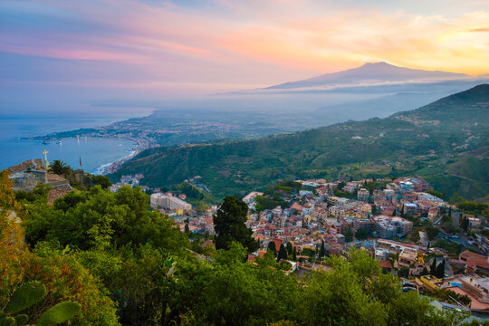 Italy, Sicily, Taormina with Mount Etna at sunset