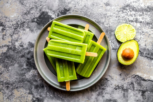 Bowl of avocado lime ice lollies