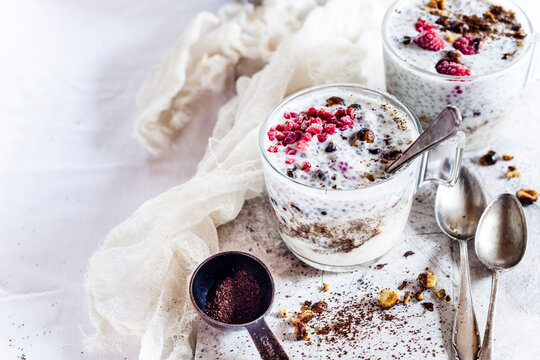 Glasses of yogurt dessert with chia, roasted hazelnuts and