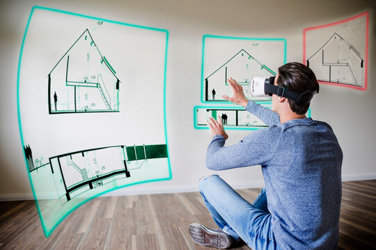 Man in apartment wearing VR glasses exploring house