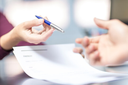Handing over of a pen over document