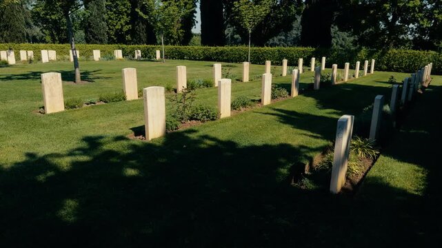 Rows Of Headstones In Green Cemetery
