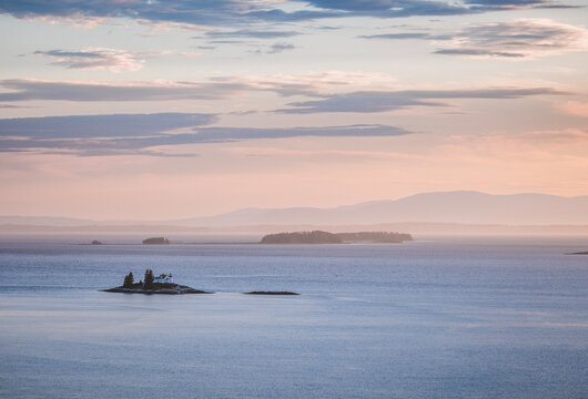 Small lighthouse on a remote island at twilight, Penobscot Bay, Maine