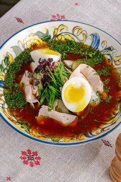 Bowl of traditional okroshka soup with egg and chicken