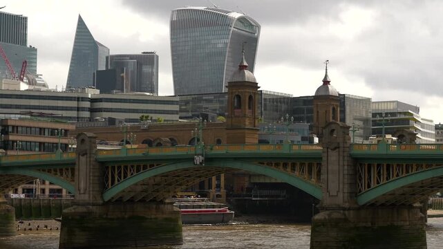 Southwark Bridge over River Thames with iconic City of London skyscrapers rising behind