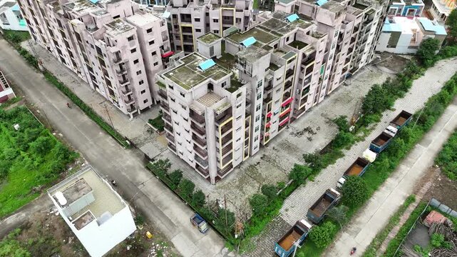 Cinematic drone perspective of residential buildings, well-planned roads, and houses in Katara Hills.