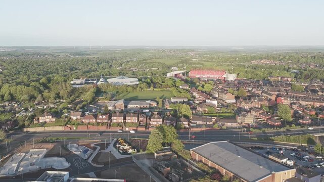 Barnsley South Yorkshire England showing Oakwell Stadium, residential neighborhoods, Sheffield Road corridor and surrounding woodland landscape during static high angle drone aerial shot