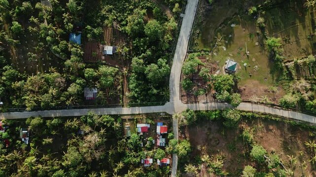 Bird&rsquo;s-eye aerial view of rural road junction in Virac, Catanduanes, showing rural barangay villages, farmland, and tropical greenery