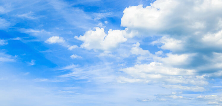 Beautiful vibrant blue sky background with colorful soft white clouds for inspirational nature wallpaper panorama mockup