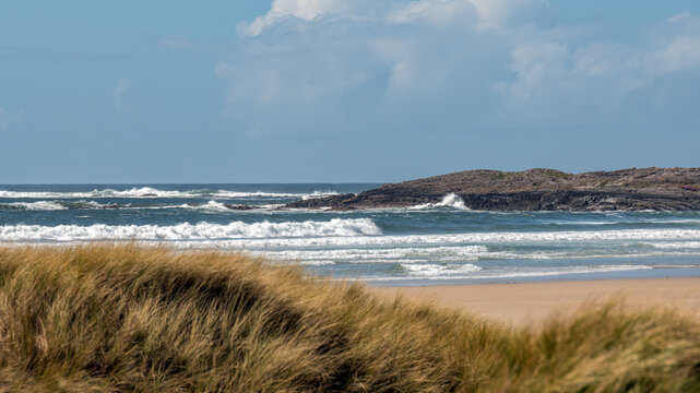 dramatic coastal landscape at machir bay beach on the isle of islay in scotland with rolling Atlantic waves.