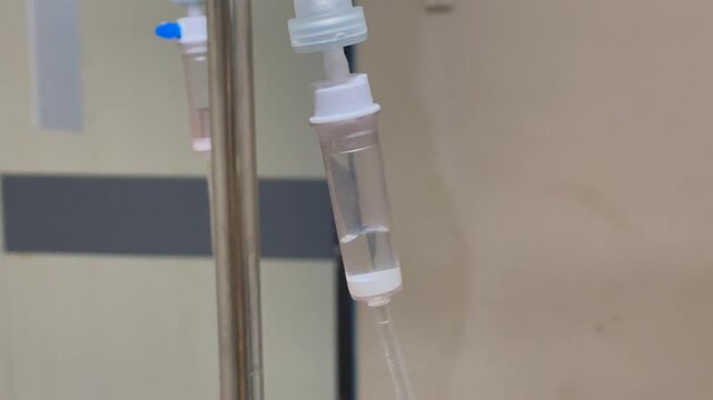 Intravenous drip infusion set in a hospital room.