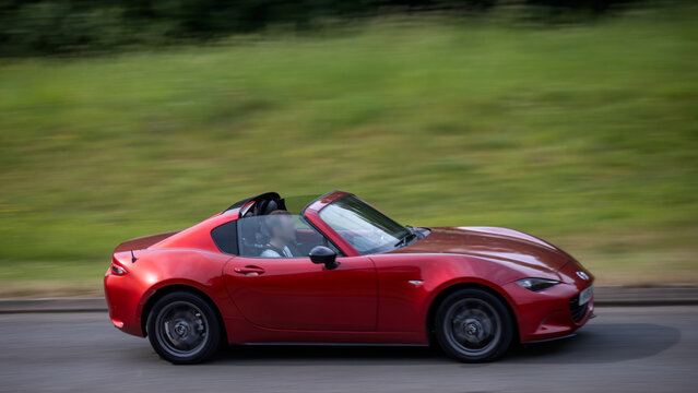 Milton Keynes,Bucks,UK - May 28th:  2018 red Mazda mx5 convertible car driving on a British road