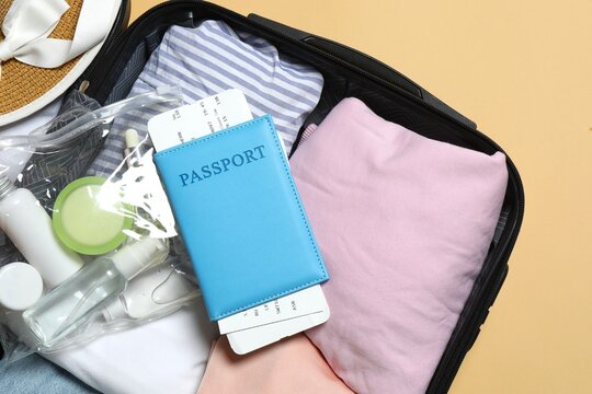 Travel background, summer holidays. Suitcase, passport, on blue background. Flat lay