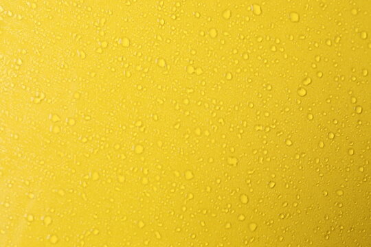 Water drops on yellow background