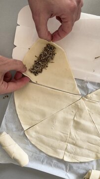 Homemade za'atar pastry rolls being assembled on baking parchment paper