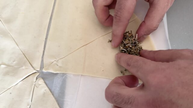 Homemade za'atar pastry rolls being assembled on baking parchment paper