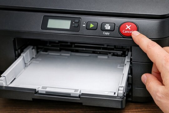A close-up view of someone pressing the print button on a printer