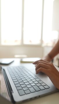 Software engineer intensely coding by luminous window with dedicated flow