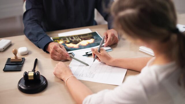 Insurance Agent Carefully Reviews Claim Forms