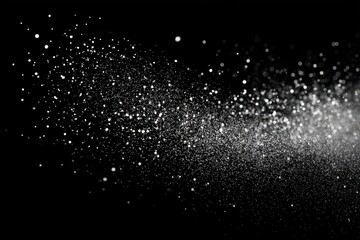 Fototapeta premium A mesmerizing spray of white particles against a stark black background.