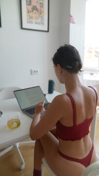 Lady develops visual aids while analyzing graphs on her computer
