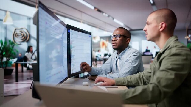 IT Service Managers Collaborating At Desk Using Software