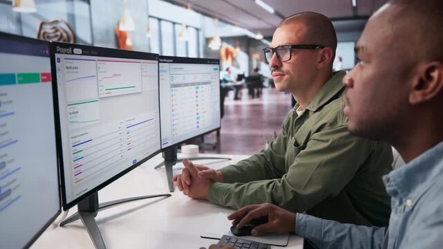Payroll Manager And Assistant Discuss Employee Salary Automation Process