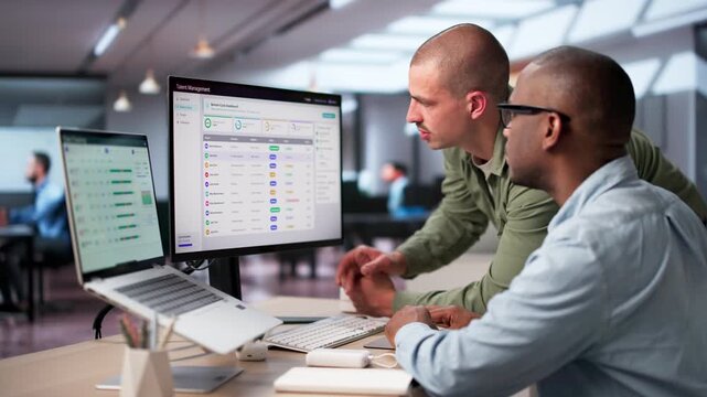 HR Manager Reviews Employee Performance Using Software