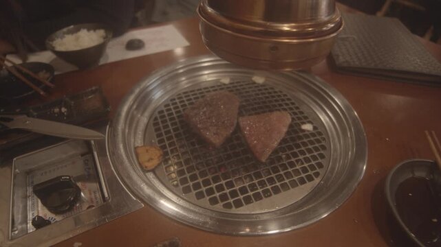 Yakiniku restaurant scene in Japan showing diners waiting for the server, capturing a casual Japanese dining experience and restaurant atmosphere.