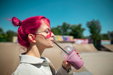 Side Profile Portrait of Young Urban Woman with Pink Hair Drinking Beverage Outdoors ©  IRIS AIKO