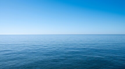 Fototapeta premium Breathtaking view of the vast blue ocean meeting the clear sky at the horizon line during a calm day, showcasing the serene beauty of the sea, endless water, and peaceful maritime atmosphere.