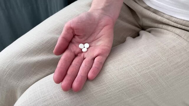 A woman takes a pill, taking an antihistamine, relieving symptoms of skin allergies and irritation. Top view, close up