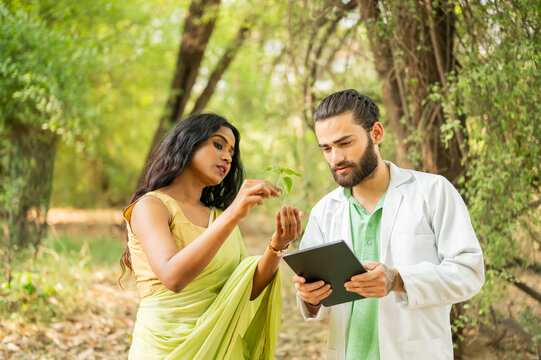 Indian scientists researching plants in a forest