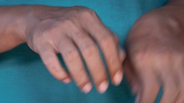 Asian man's hand Scratching itchy wrist close up