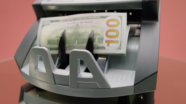 Hand Taking Cash From Money Counter Isolated on Pink