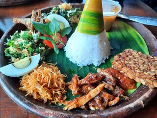 Indonesian food called nasi tumpeng. © Conjac Studio