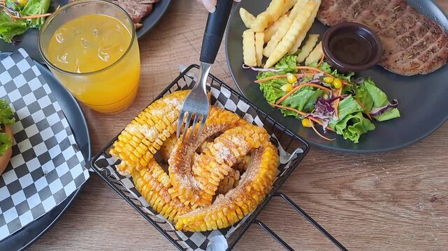 Gourmet steak house platter featuring Rib Eye, Sirloin, and Ribs Corn with a large double-meat burger. Cinematic camera movements from close-up to eagle eye view. Luxury dining experience. 4K.