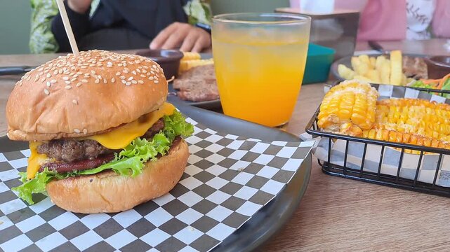 Gourmet steak house platter featuring Rib Eye, Sirloin, and Ribs Corn with a large double-meat burger. Cinematic camera movements from close-up to eagle eye view. Luxury dining experience. 4K.