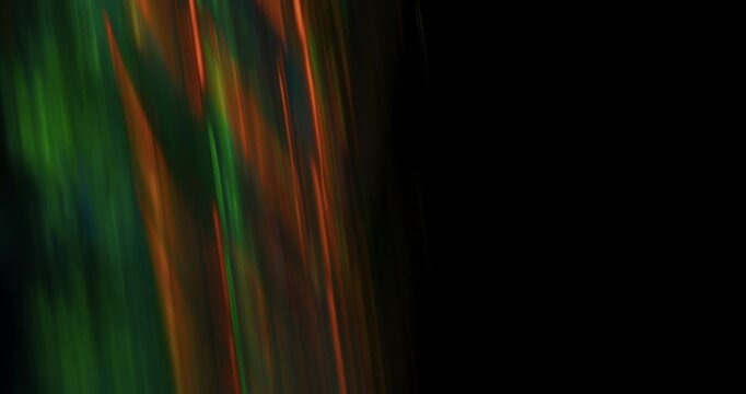 This dynamic abstract background showcases a captivating fluid motion with vibrant green and orange colors, making it an ideal choice for motion graphics and various creative design projects
