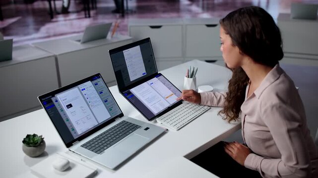 Young Hispanic Woman Working On Document Management System For Office