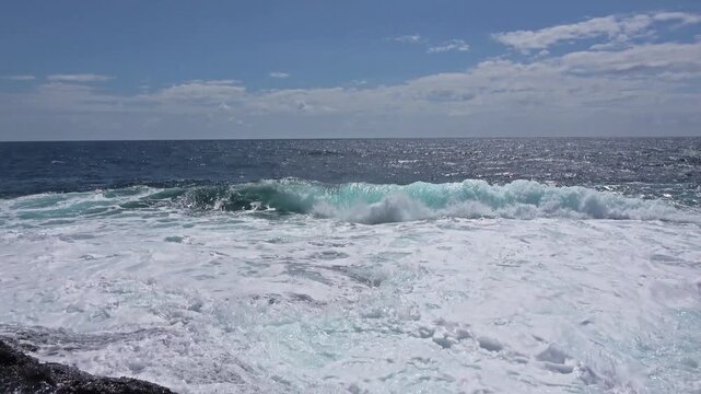 Sea waves crashing on shore creating foam