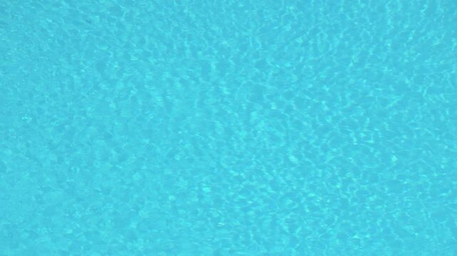 Blue swimming pool water surface ripple texture background