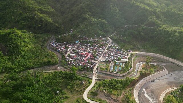 Scenic aerial orbit of Barangay Obi in Caramoran, Catanduanes, showing an isolated rural village surrounded by lush tropical hills