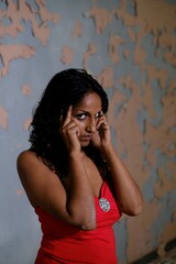 Fototapeta premium dark-skinned Indian model, poses for sensual and glamorous photos in studio for magazines and advertising