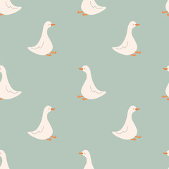 Obraz premium Seamless pattern with white geese on a sage green background. The textile print features domestic birds with orange beaks arranged in a geometric repeating layout for modern wallpaper.