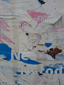 Torn and ripped street poster, grungy background, messy old paper collage