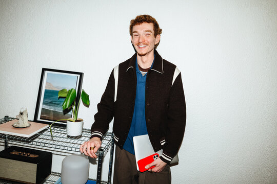 The technology in this home scene follows a young man using a tablet and smartphone.