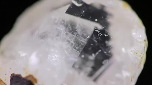Macro shot of a clear quartz crystal with inclusions.