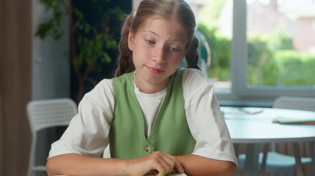 Frustrated Caucasian girl little girl child kid doubtful pupil looking at camera shrugging shoulders at school studying problem daughter shrug hesitate reaction fail exam difficult study education