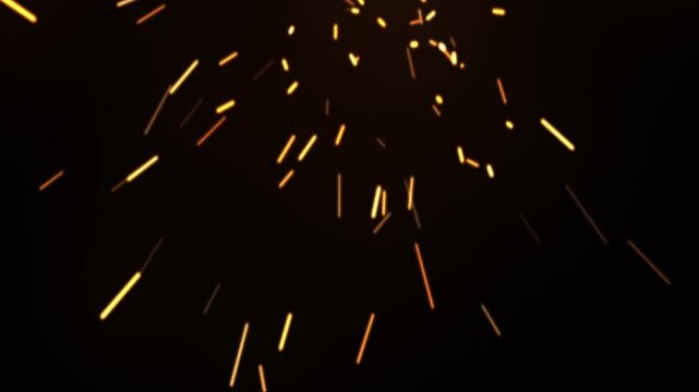 Fiery Yellow Sparks and Embers Flying Upwards on a Black Background.